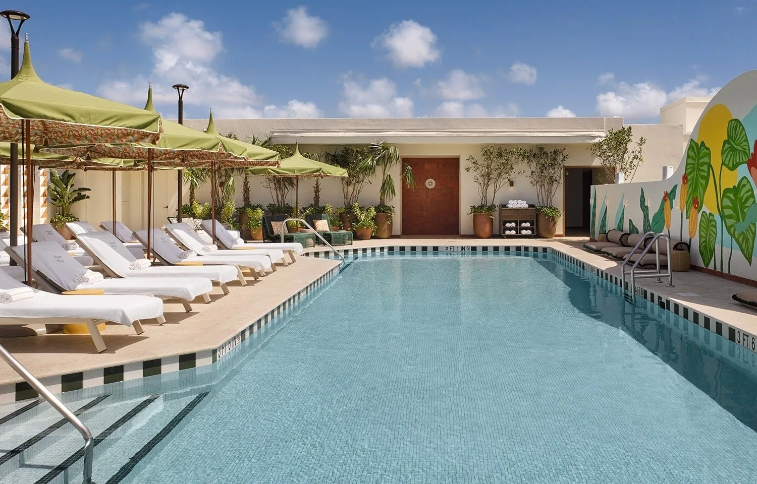 Image may contain Pool Water Architecture Building House Housing Villa Swimming Pool Plant Outdoors and Chair