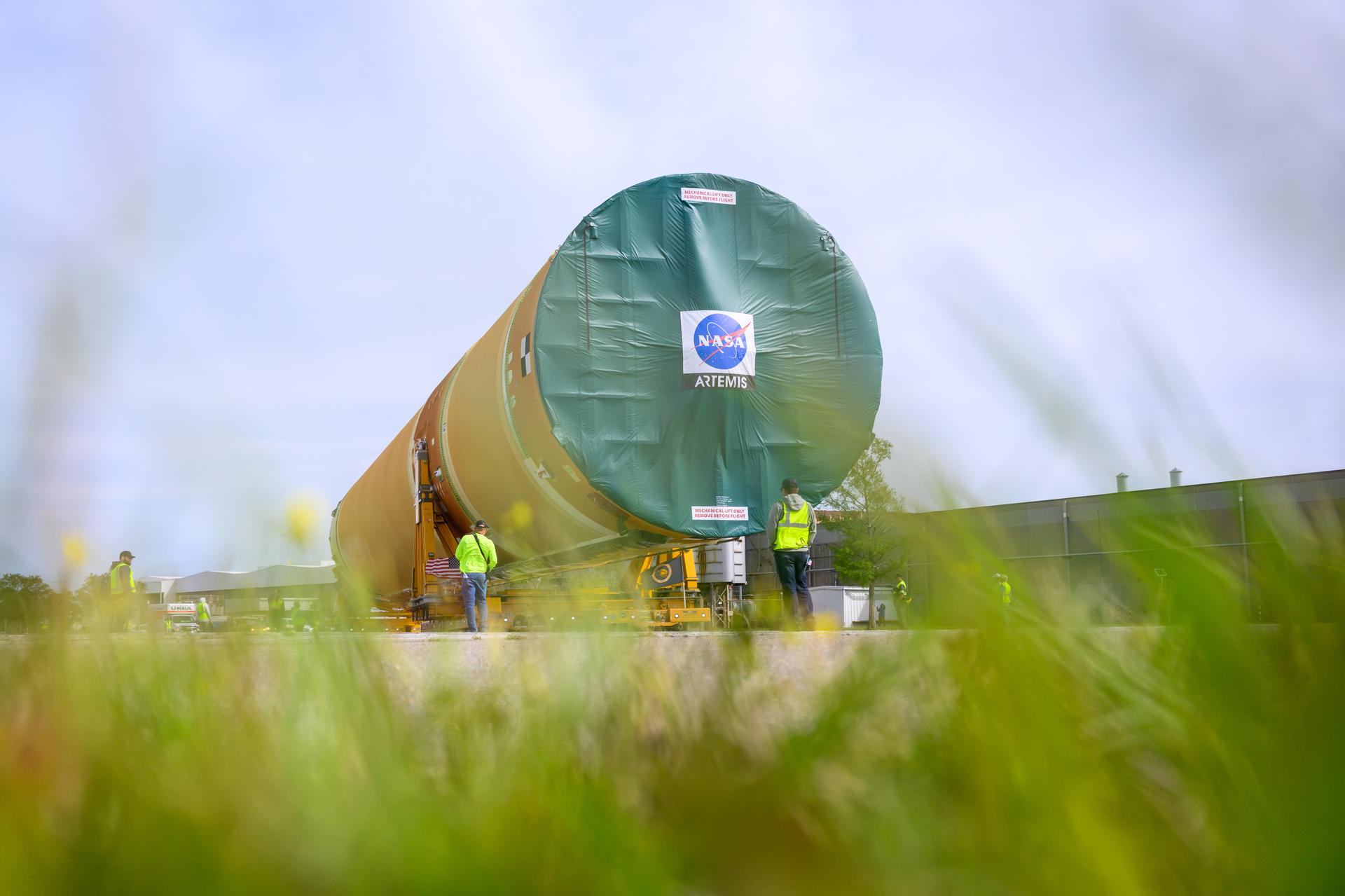 NASA moved the core stage, or the largest section, of the SLS (Space Launch System) rocket that will launch the crewed Artemis III mission in 2027 from the agency’s Michoud Assembly Facility to the agency’s Pegasus barge in New Orleans on April 20. The barge will ferry the top four-fifths – the section containing the liquid hydrogen tank, liquid oxygen tank, intertank, and forward skirt – of the SLS core stage to NASA’s Kennedy Space Center in Florida to complete outfitting and vertical integration.  Teams with NASA and Boeing, the SLS core stage lead contractor, used specialized transporters to guide the top four-fifths from the NASA rocket factory to Pegasus. Prior to the move, technicians added an engine section transportation simulator to the rocket stage for shipment to the Space Coast.  Next year’s Artemis III mission will launch astronauts to Earth’s orbit aboard the Orion spacecraft on top of SLS to test rendezvous and docking capabilities between Orion and commercial spacecraft needed to land Artemis IV astronauts on the Moon in 2028. NASA’s SLS is the only rocket capable of sending Orion, astronauts, and supplies to the Moon in a single launch.   Photo Credit: NASA/Eric Bordelon
